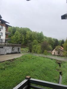 a park with a field of grass and a fence at Trialeti Sweet Home in Bakuriani