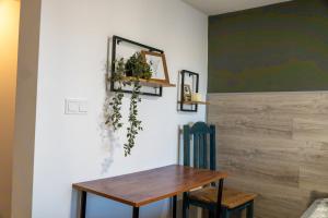 a dining room with a wooden table and two chairs at Guest House Malusha in Gabrovo