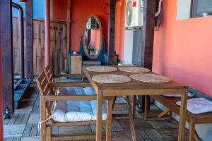 a wooden table and chairs in a room at Guest House Malusha in Gabrovo