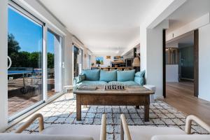 a living room with a blue couch and a table at La Villa Des Caps - Entre centre-ville et port in Erquy +25 photos
