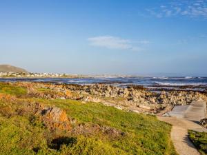 a view of the ocean and a rocky beach at Two Palm House - Vermont Hermanus in Hermanus
