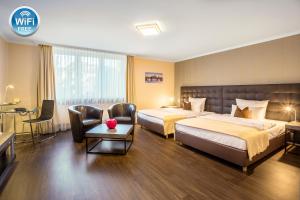 Cama ou camas em um quarto em Villa Westend Hotel an der Messe