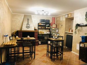 a kitchen with tables and stools in a room at BB Diesis in Ferrazzano