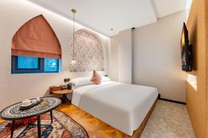 Rúm í herbergi á Chaozhou Fanhuali B&B