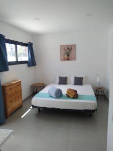 a bedroom with a bed with blue pillows on it at Yumbo Rainbow Homes D in Maspalomas