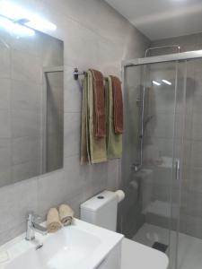 a bathroom with a shower and a sink and a toilet at Yumbo Rainbow Homes D in Maspalomas +19 photos