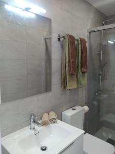 a bathroom with a sink and a toilet and a shower at Yumbo Rainbow Homes D in Maspalomas