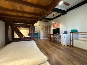 a bedroom with a bed and a dining room at The Stage-Koh Chang in Ko Chang