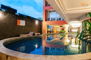a swimming pool in the middle of a building at Siesta Legian in Legian