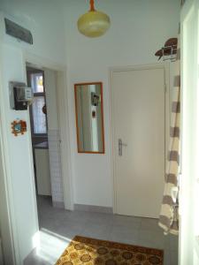 a hallway with a white door and a mirror at Sissi Residence with free parking lot in Budapest
