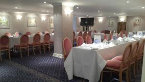 a row of tables and chairs in a room at Hotel Riviera in Sidmouth