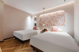 Rúm í herbergi á Chaozhou Fanhuali B&B
