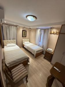 a hotel room with two beds and a table at Vita Mundo in Kotor