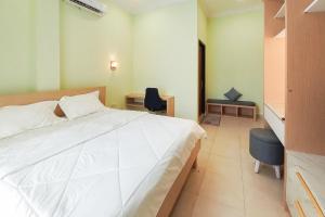 Postel nebo postele na pokoji v ubytování RedDoorz Syariah at UIN Suska GuestHouse + 20 fotografií