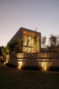 a building with lights in front of it at Usawa Villa Nyanyi in Munggu