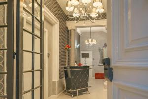 a hallway with a mirror and a chandelier and a hallway with a hallway at Sliema Central Iprime Suites in Sliema