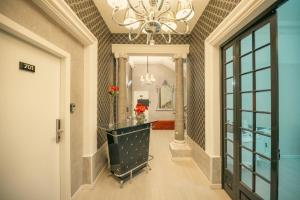a hallway of a home with a chandelier at Sliema Central Iprime Suites in Sliema