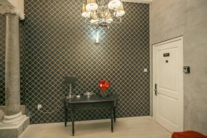 a room with a table and a chandelier at Sliema Central Iprime Suites in Sliema