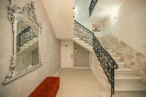 a staircase in a house with a mirror at Sliema Central Iprime Suites in Sliema