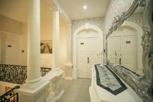 a large room with a bed and a mirror at Sliema Central Iprime Suites in Sliema
