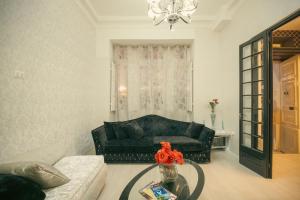 a living room with a couch and a glass table at Sliema Central Iprime Suites in Sliema