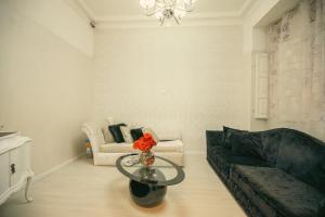 a living room with a couch and a table at Sliema Central Iprime Suites in Sliema