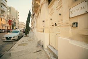 a car parked on a street next to a building at Sliema Central Iprime Suites in Sliema