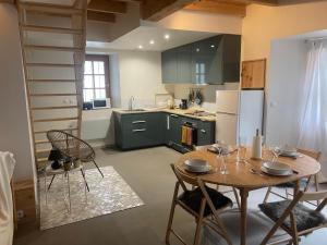 a kitchen with a table and chairs in a room at Maison So de Cloze in Luz-Saint-Sauveur