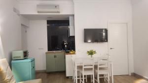 a kitchen with a table and chairs in a room at Apartamentos Rey 2 in Prado del Rey