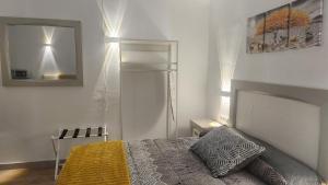 a bedroom with a bed and a mirror at Apartamentos Rey 2 in Prado del Rey