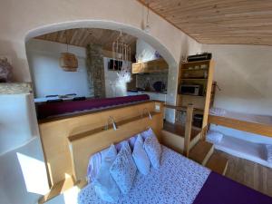 a small room with a bed and a kitchen at Can Banal - Camping y Masia Rural in Montagut +53 photos