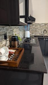 a kitchen with a counter with a wooden cutting board at Nuwans Countryside Apartment in Tangalle