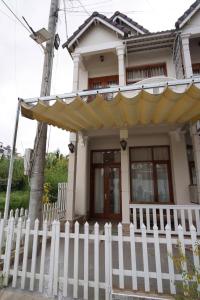 a white fence in front of a house at 2bi s home DALAT 2 in Da Lat +9 photos