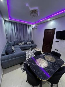 a living room with a couch and a table at KECHDAYS, Apartment near airport in Marrakech
