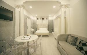 a living room with a couch and a table at Sliema Central Iprime Suites in Sliema
