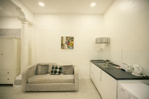 a kitchen with a couch and a sink in a room at Sliema Central Iprime Suites in Sliema