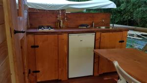 an outdoor kitchen with a sink and a stove at Camping RioRequesa in Campore +33 photos