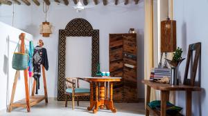 a room with a mirror and a table and chairs at Infinity Beach Boutique Hotel & SPA in Matemwe +56 photos