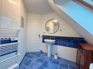 a bathroom with a sink and a mirror at Maison des Dunes in Plougoulm +36 photos