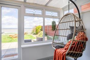a swing in a room with a window at Seaview Symphony Opulent 4BR Haven for Big Groups in Birchington
