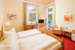 a bedroom with a bed and a living room at Solehotel Winterberg in Bad Harzburg +53 photos