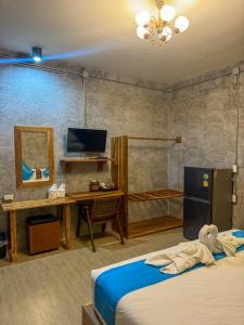 a bedroom with a bed and a desk with a mirror at Love Room - Center Thong Sala - Swimming Pool in Thongsala