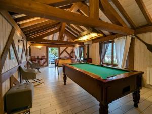a large room with a pool table in it at Chalet cosy avec spa et sauna, animaux admis - FR-1-589-673 in Fresse-sur-Moselle
