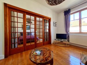 a living room with a table and a television at Bel appart au centre avec terrasse et parking - FR-1-589-674 in Gérardmer