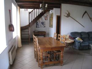 a dining room with a table and a couch at Gîte en Lorraine : 3 ch, jardin, proche Lac de Madine - FR-1-584-335 in Saint-Baussant