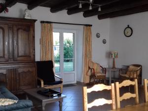 a living room with a couch and a table at Gîte en Lorraine : 3 ch, jardin, proche Lac de Madine - FR-1-584-335 in Saint-Baussant