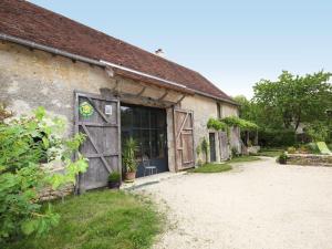 a building with a door with a sign on it at Grange éco-rénovée au cœur de la nature - FR-1-591-633 in Pouligny-Saint-Pierre