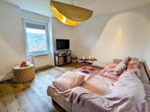 a bedroom with a large bed and a television at Appartement rénové avec jardin, parking et WiFi à Gérardmer - FR-1-589-678 in Gérardmer