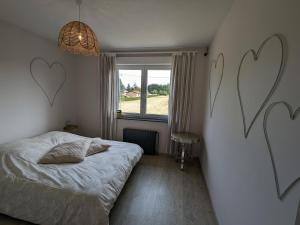 a bedroom with hearts painted on the wall at Maison spacieuse avec spa, animaux acceptés, près d'Épinal - FR-1-589-680 in Dounoux