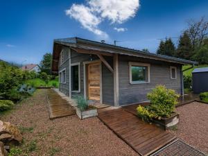 a tiny house with a porch and a deck at Chalet de charme pour 6 pers., proche ski, WiFi, parking, animaux admis - FR-1-589-683 in Cornimont